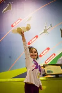 Child playing at airplane exhibit.