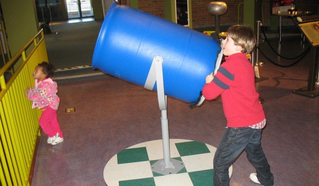 Child playing with Air Cannon exhibit.