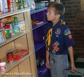 Boy Scout shopping in Discovery Town groccery store.